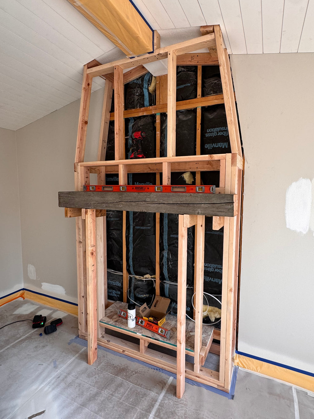 Custom Installtion with stacked Stone, framing and mantel