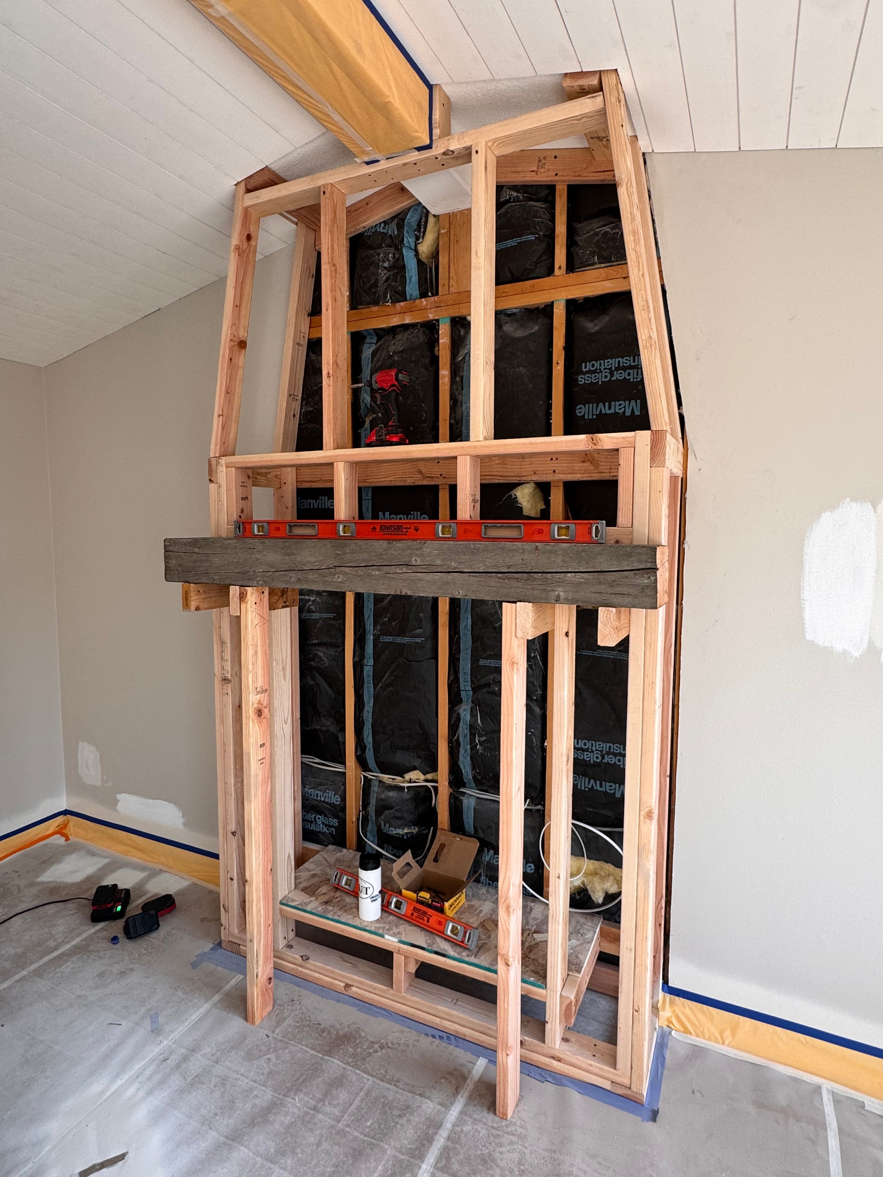 Custom Installtion with stacked Stone, framing and mantel