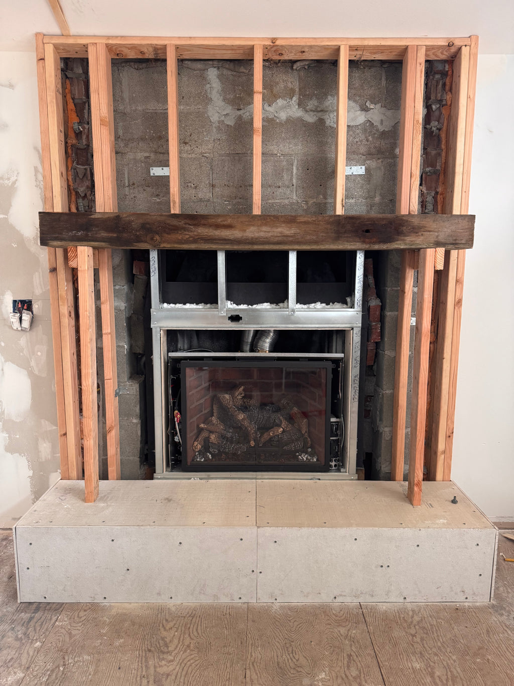 Custom Installtion with stacked Stone, framing and mantel
