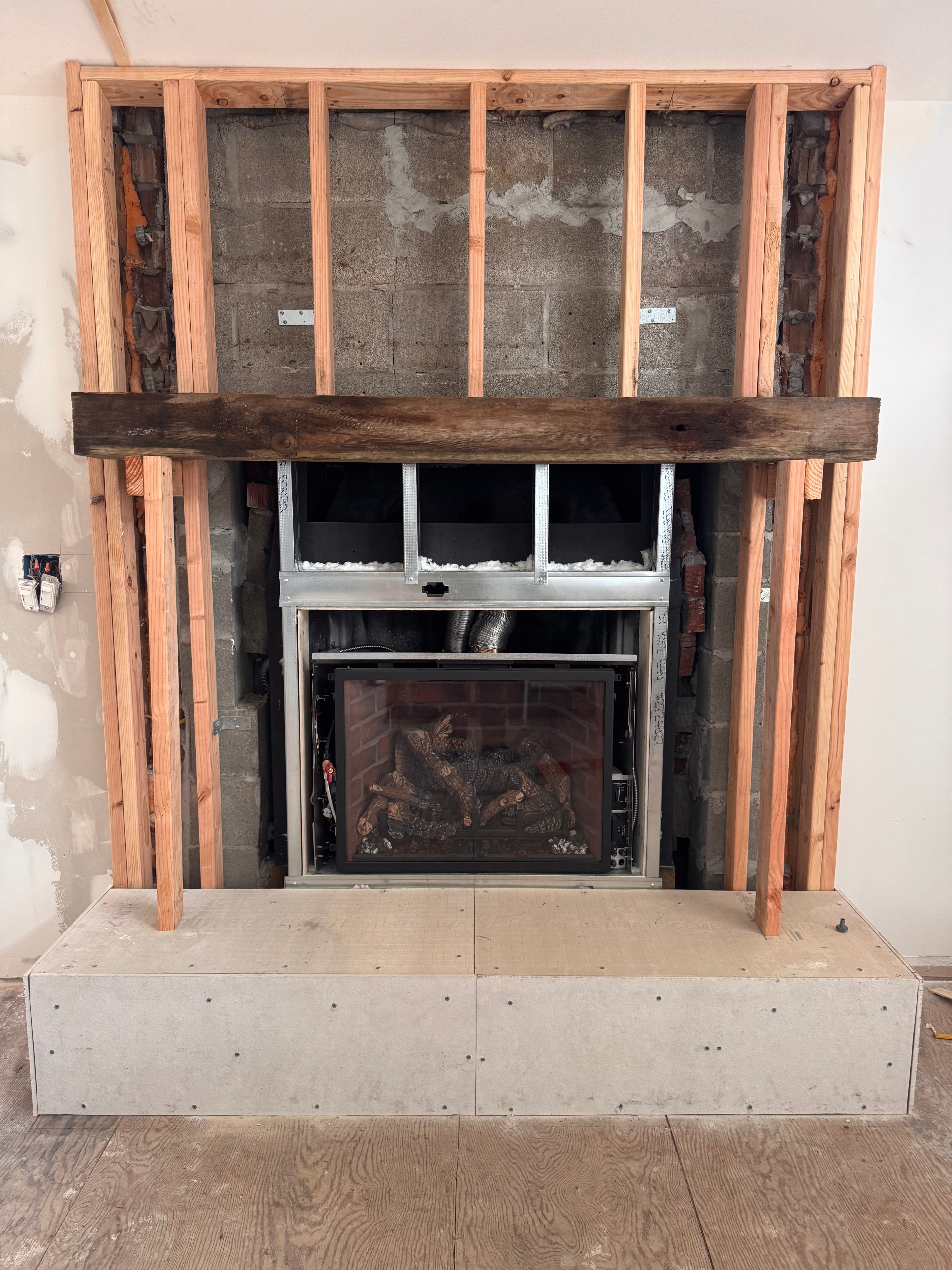 Custom Installtion with stacked Stone, framing and mantel